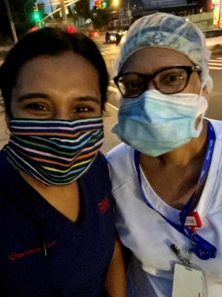 Two women in masks with smiling eyes