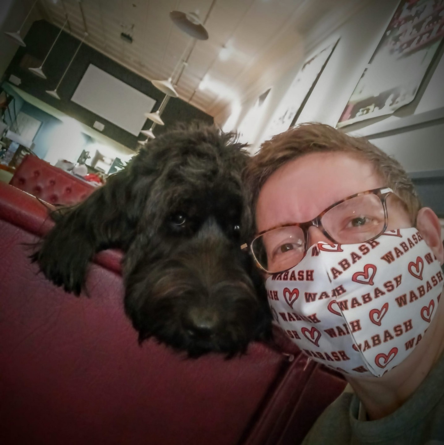 A masked survivor and her fluffy dog