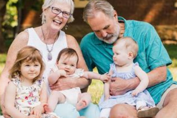 Happy grandparents with three very young grandchildren